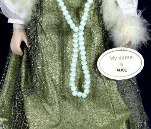 Porcelain doll  Alice in grown up clothes on stand