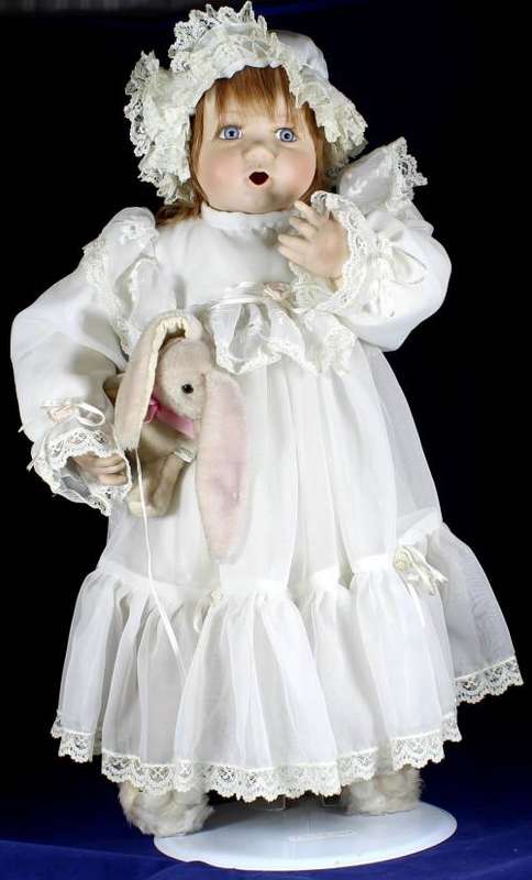 Porcelain doll - baby holding rabbit on stand
