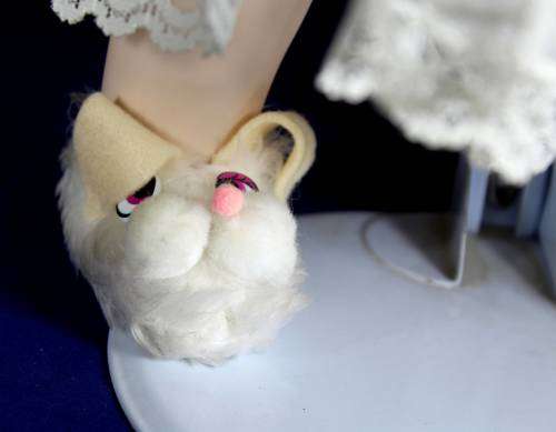 Porcelain doll - baby holding rabbit on stand