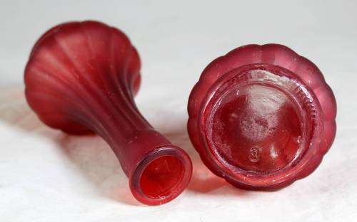 Pair of small red ornate vases