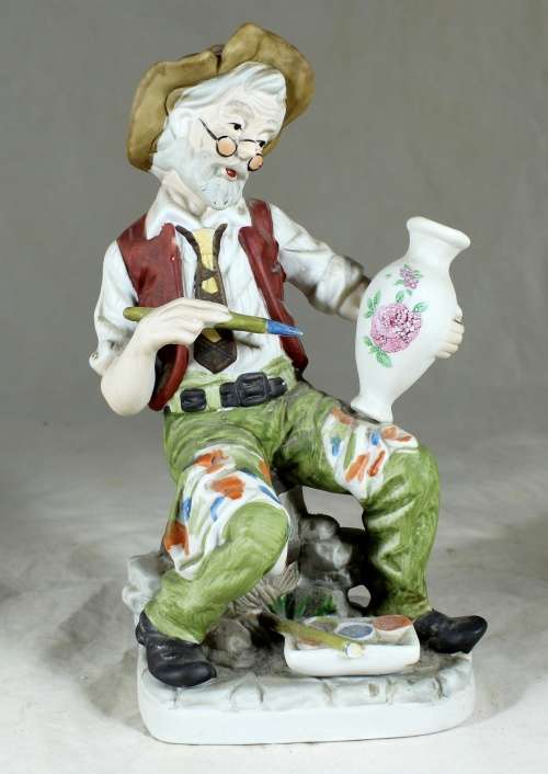 Old man painting figurine