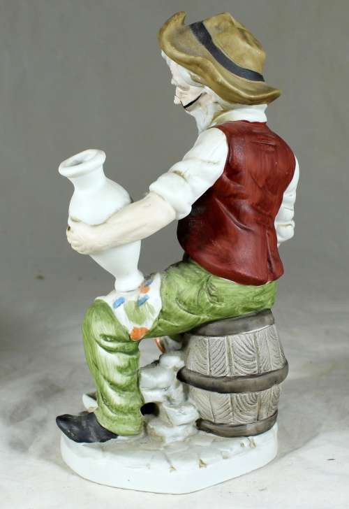 Old man painting figurine