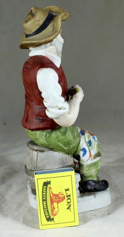 Old man painting figurine
