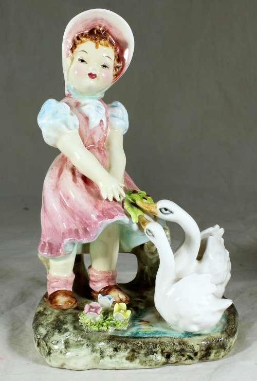 Little girl feeding the ducks figurine
