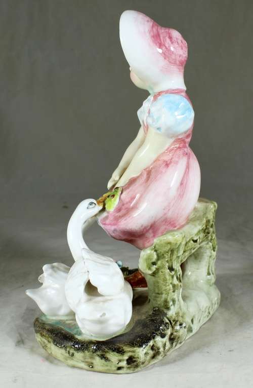 Little girl feeding the ducks figurine
