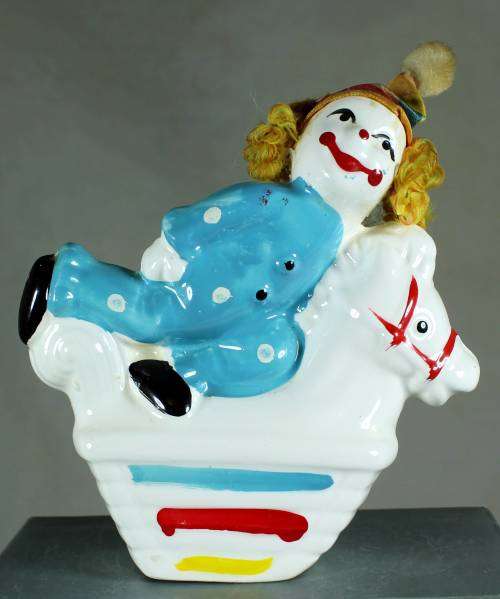 Clown figurine riding a rocking horse