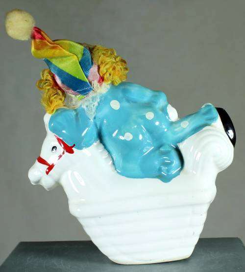 Clown figurine riding a rocking horse