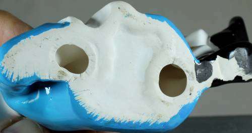 Clown figurine reclining with smile
