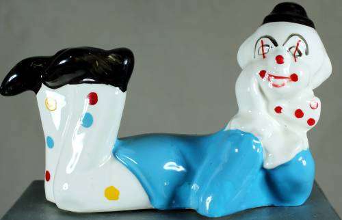 Clown figurine laying down with a smile