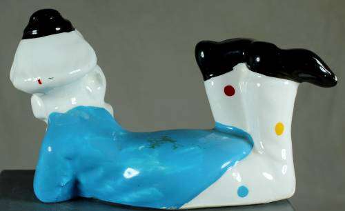 Clown figurine laying down with a smile