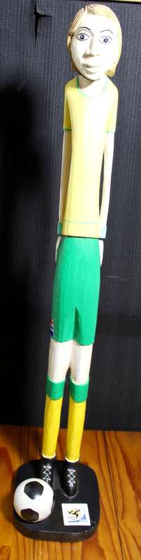 Tall carved wooden soccer player