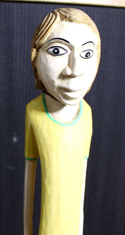 Tall carved wooden soccer player