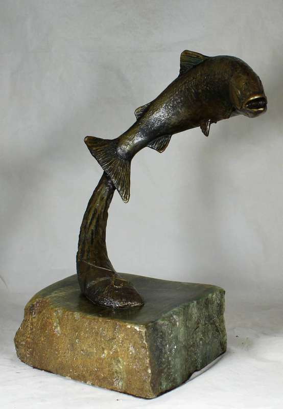 Molded fish sculpture on carved rock