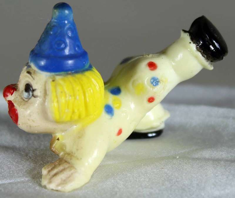 Miniature clown with leg in the air