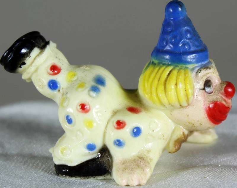 Miniature clown with leg in the air