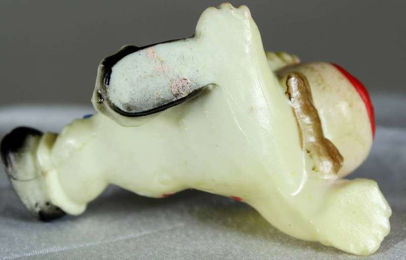Miniature clown with leg in the air
