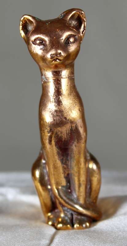Copper over lead sitting cat