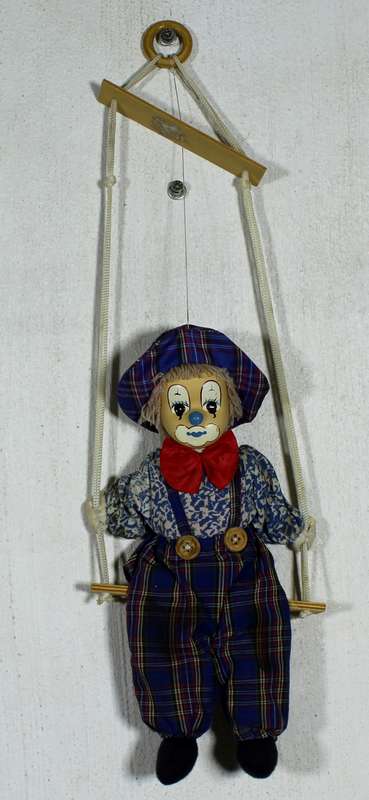Clown With Red Bow-Tie on Swing