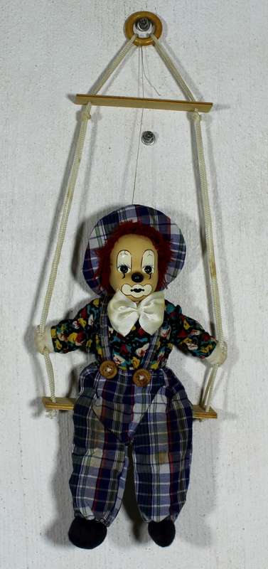 Clown With White Bow-Tie on Swing