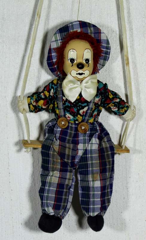 Clown With White Bow-Tie on Swing