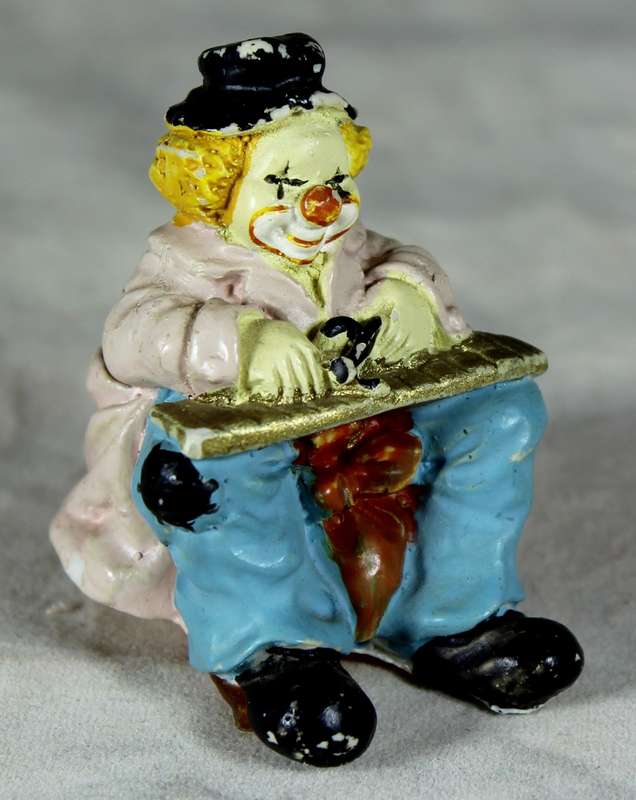 Sitting clown playing musical instrument