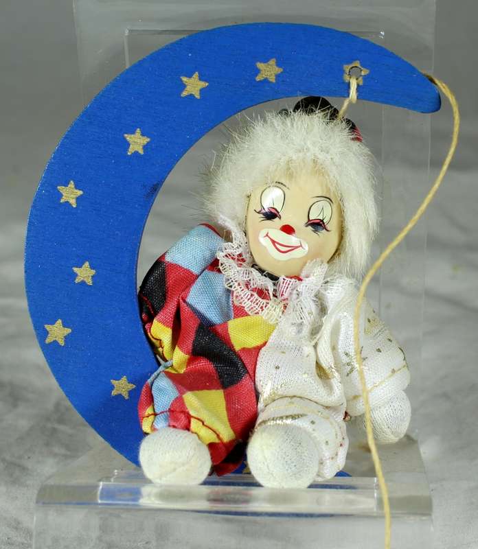 Hanging clown sitting in moon