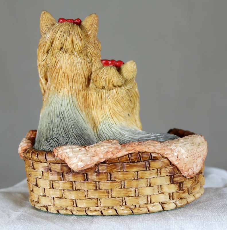 Yorkshire terriers with bows in basket