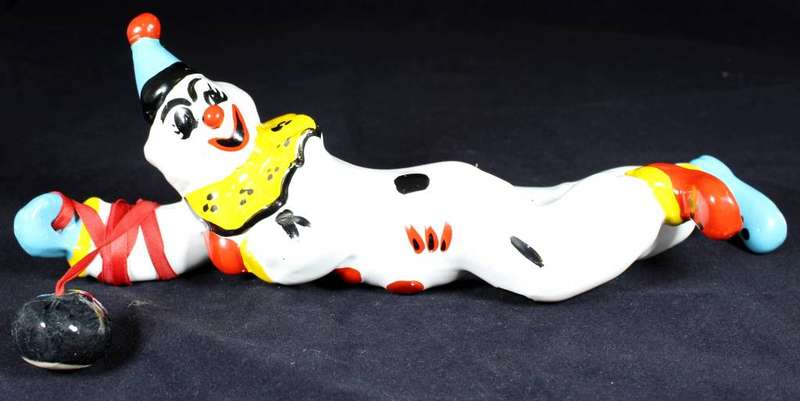 Porcelain clown hanging onto ball