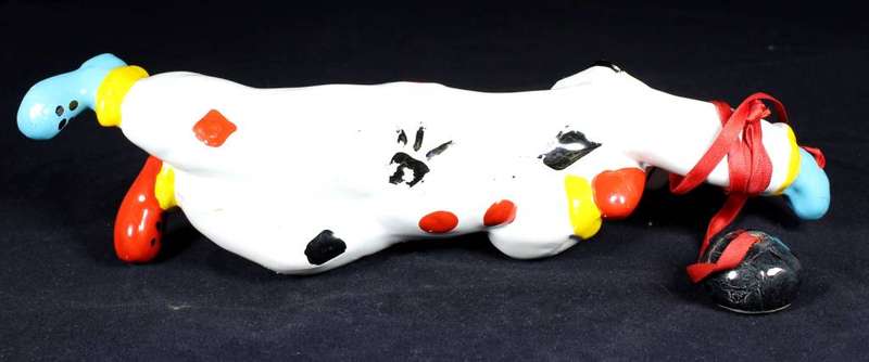 Porcelain clown hanging onto ball