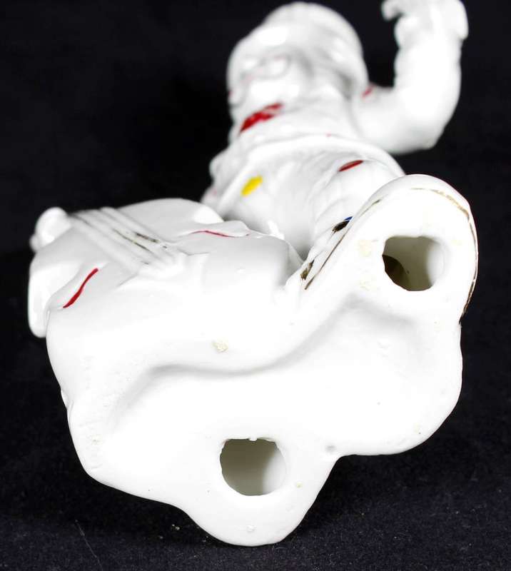 Porcelain clown with double bass