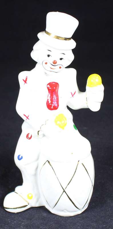 Porcelain clown beating a drum