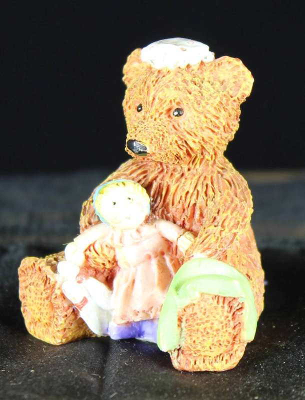 Sitting bear with doll