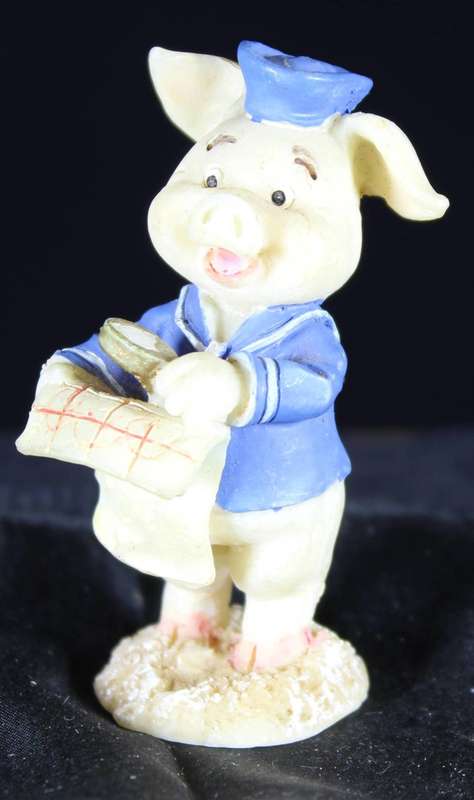Miniature piggy with map and magnifying glass