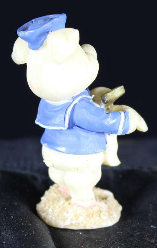 Miniature piggy with map and magnifying glass