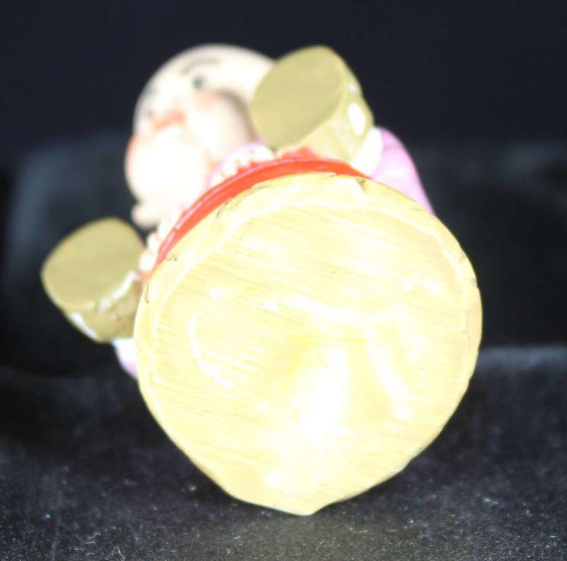 Little monk sitting on red pillow