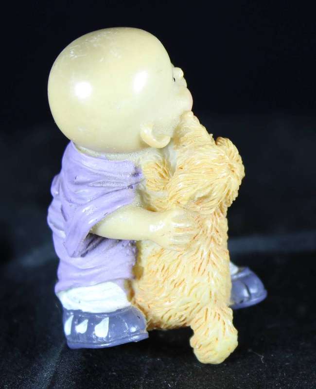 Little monk sitting with doggy