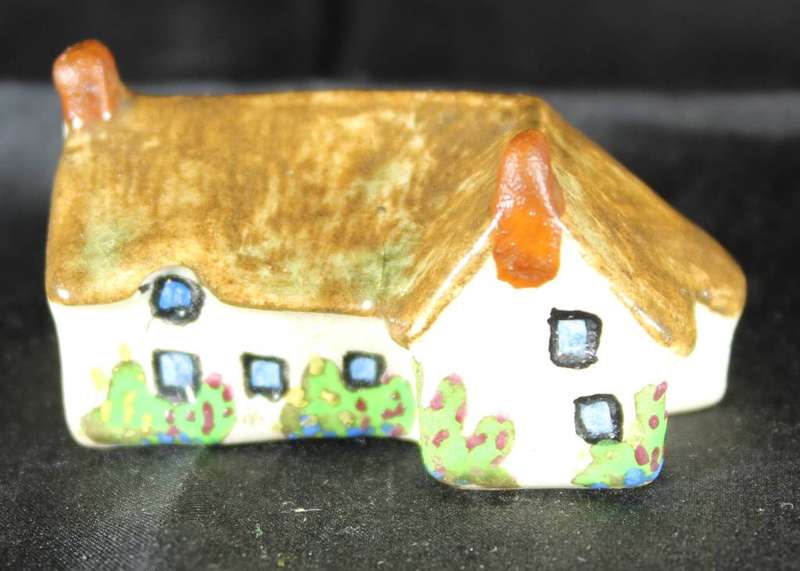 Miniature house with two chimneys & brown roof
