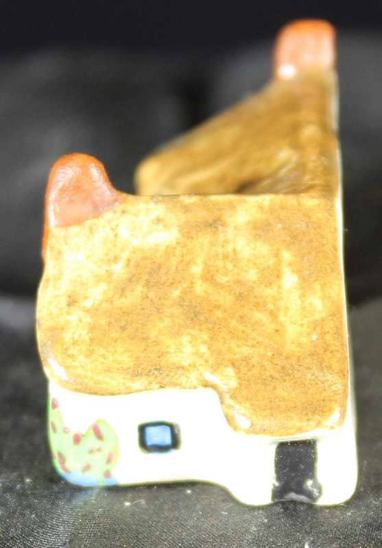 Miniature house with two chimneys & brown roof