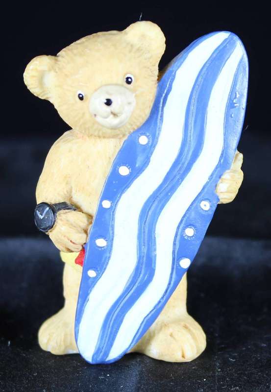 Little bear boy with surfboard