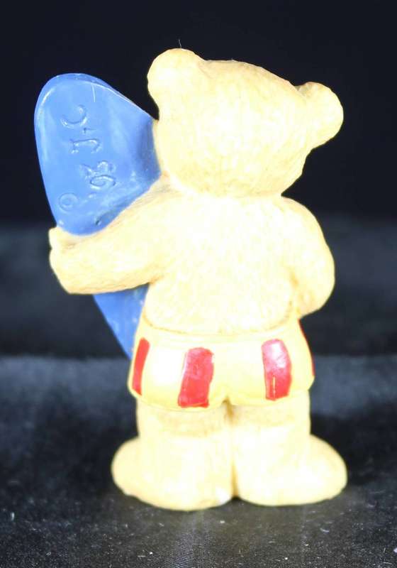 Little bear boy with surfboard