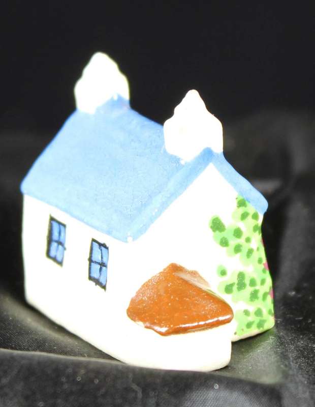 Miniature house with blue roof