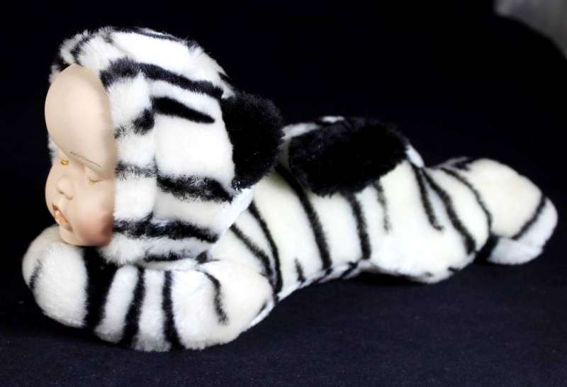 Vintage porcelain face - baby doll lying on her stomach