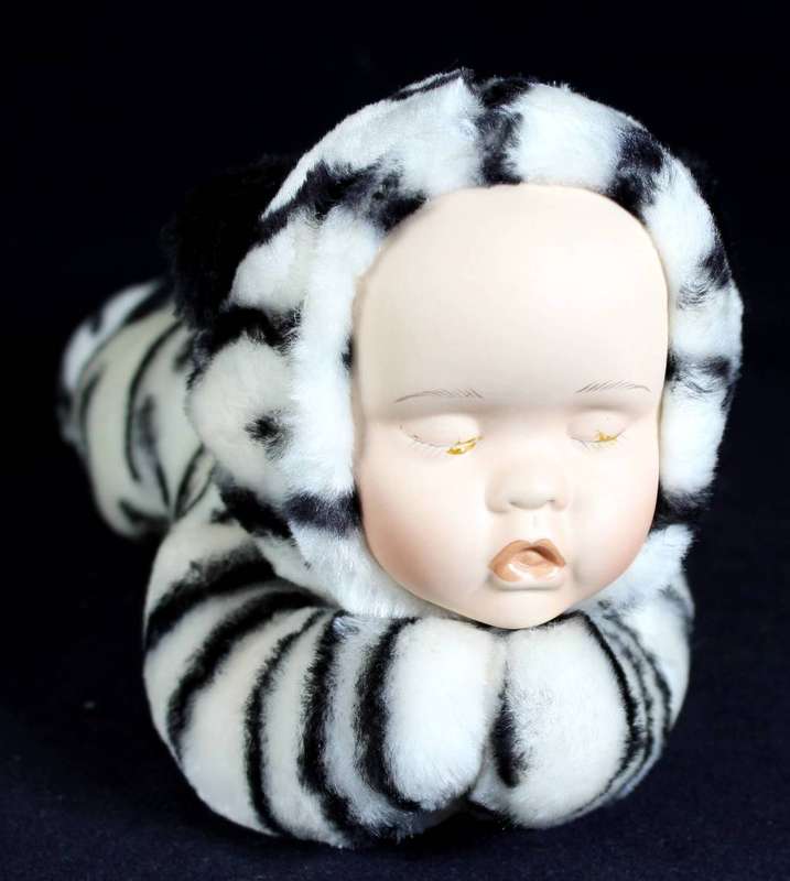Vintage porcelain face - baby doll lying on her stomach