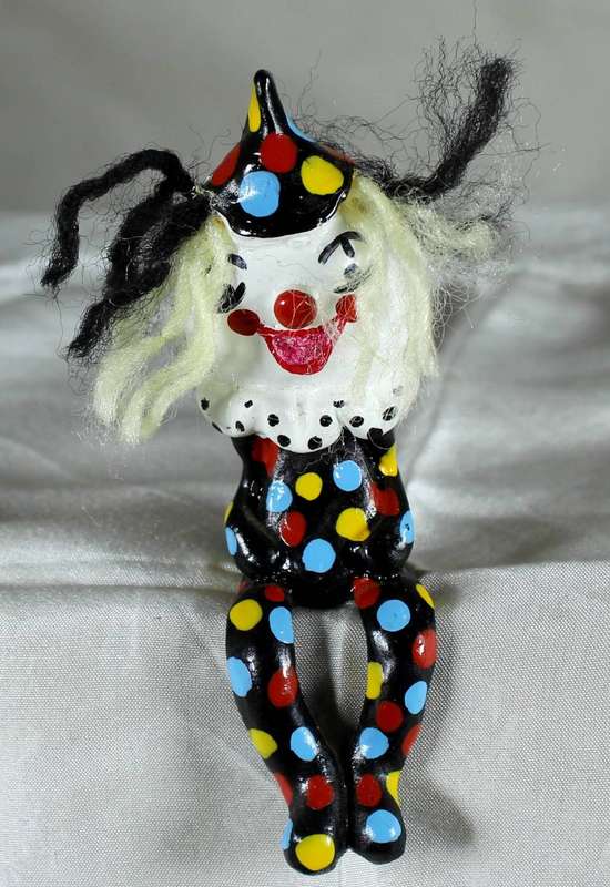 Sitting clown with legs hanging off