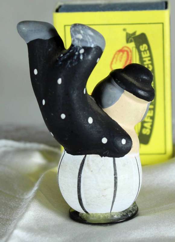 Clown on ball with a black hat