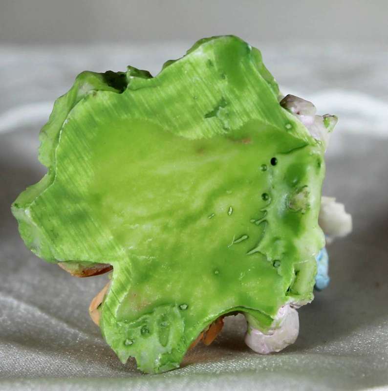 Miniature frog wearing a hat