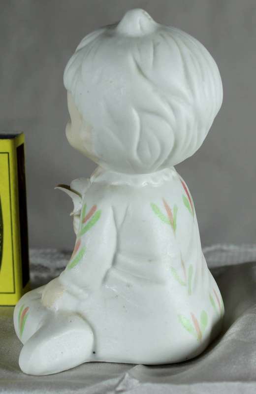 Porcelain little girl holding a flower