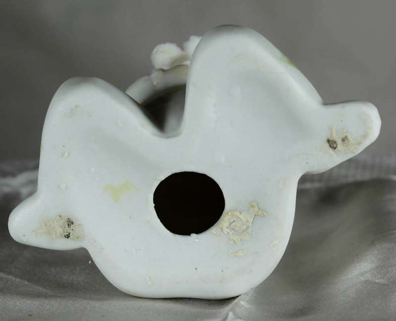 Porcelain little girl holding a flower