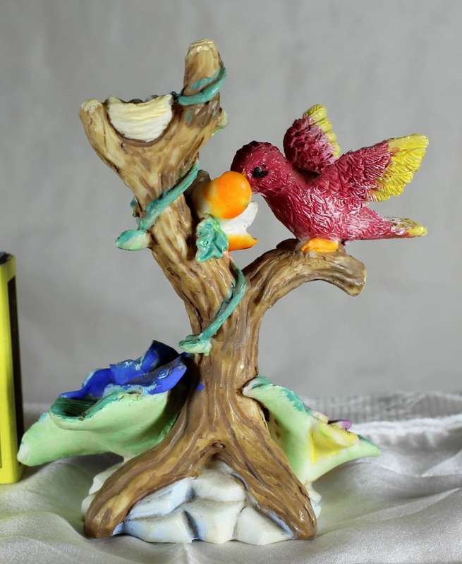 Vintage bird feeding from flower fear fer nest