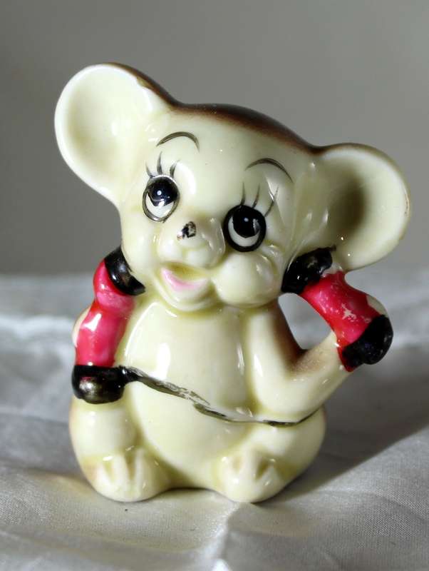 Vintage porcelain mouse lifting weights